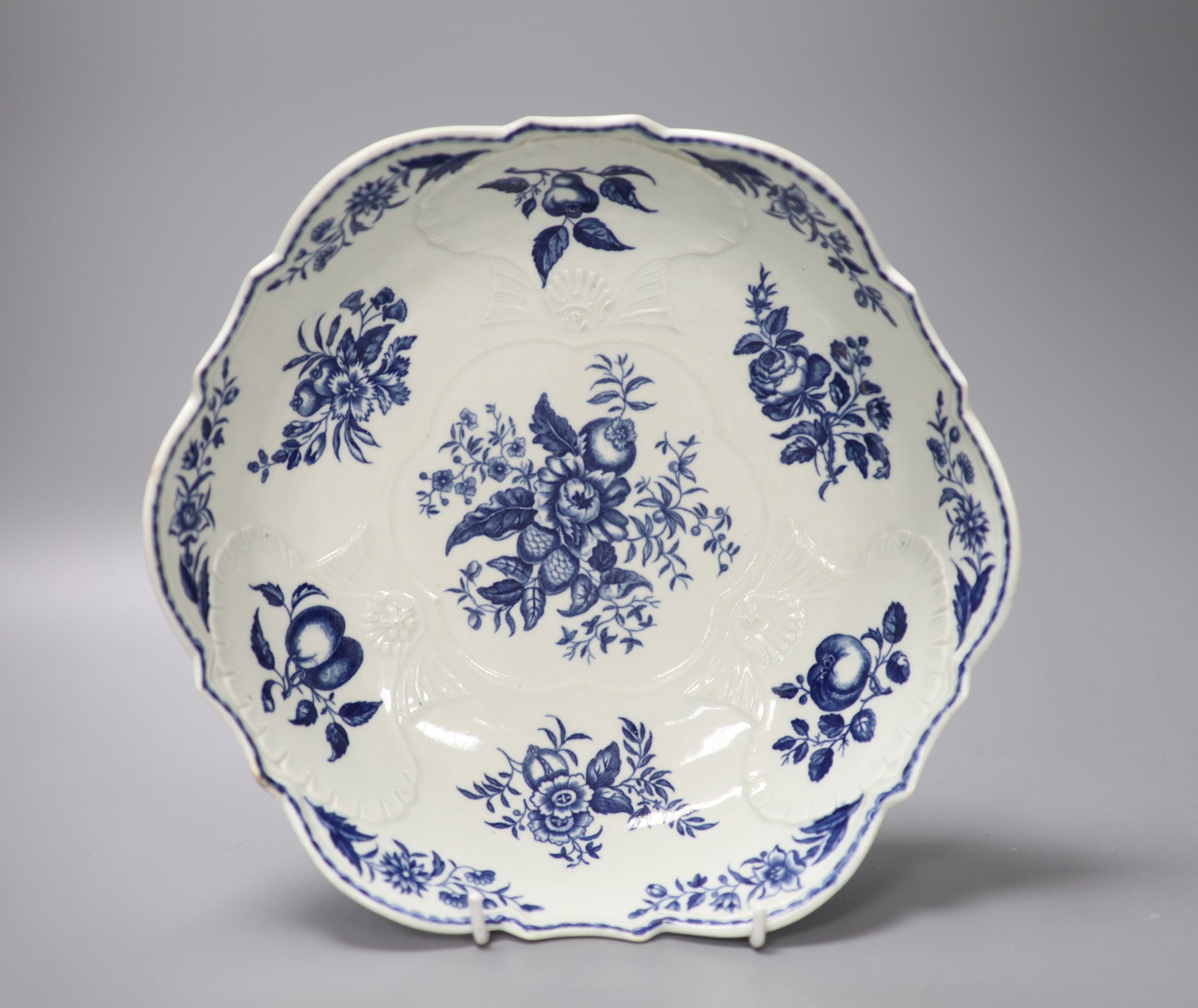 A Worcester salad bowl printed on the inside in underglaze blue with flowers, pomegranate and fir cones,